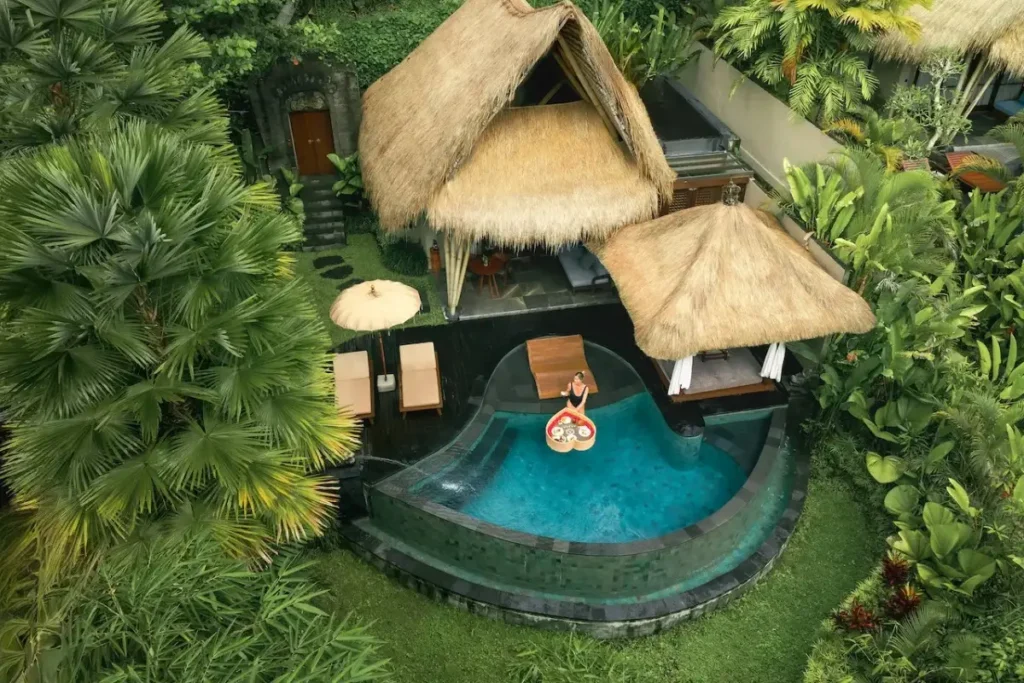 Private villa with pool and thatched roof, surrounded by jungle, showing boutique stay experience in Bali.