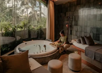 Luxury spa room with a jacuzzi and therapist preparing treatments, showing a relaxing wellness experience in Bali.