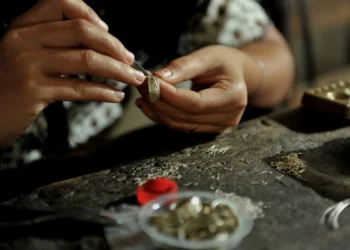 A craftsperson carefully shapes a silver piece by hand at a traditional workshop in Celuk, Bali.